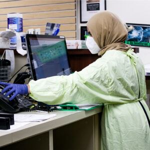 Woman With Gloves, Mask, and Protection Suit On