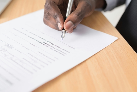 men signing document