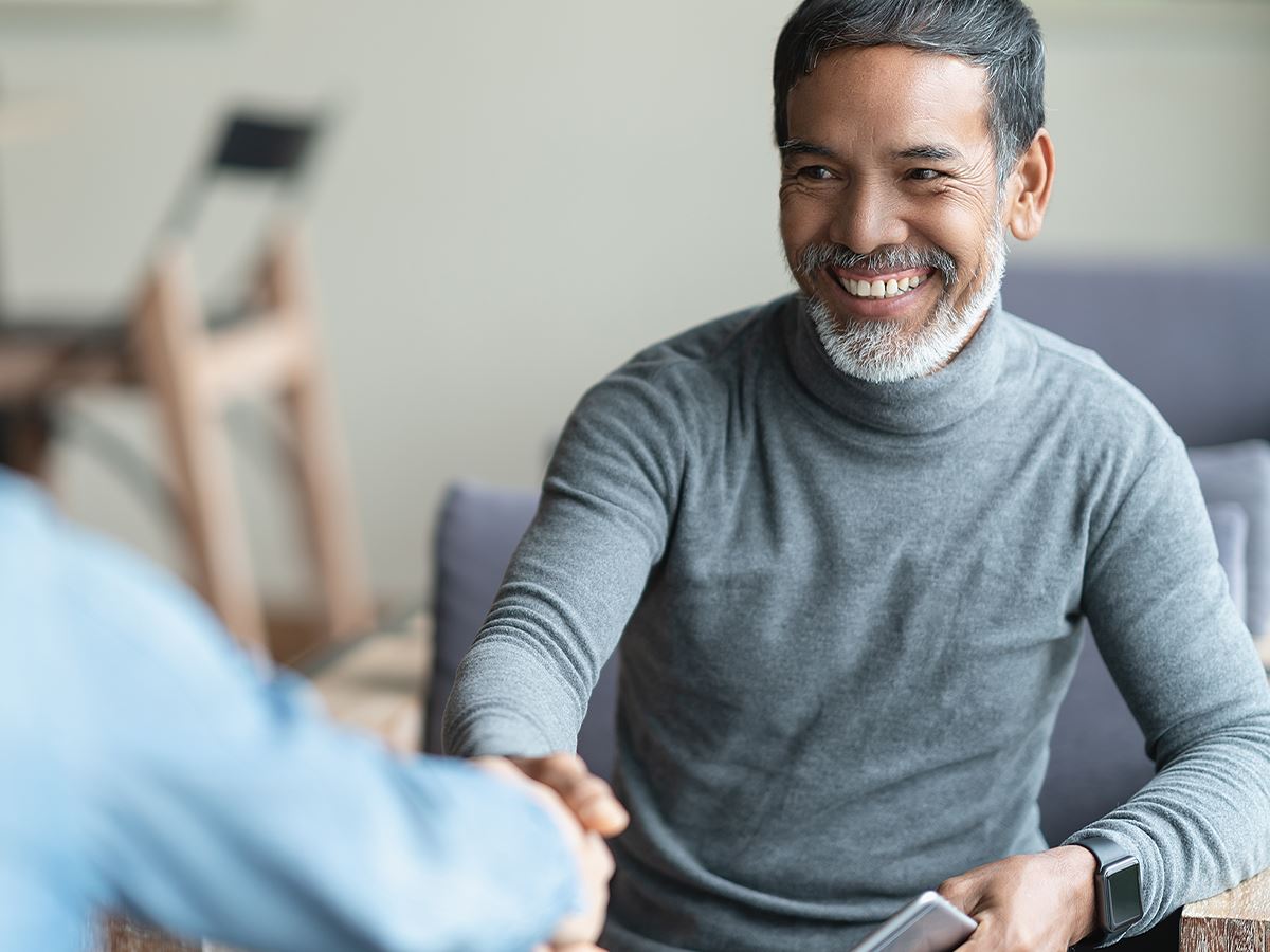 Smiling client shaking lawyer's hand