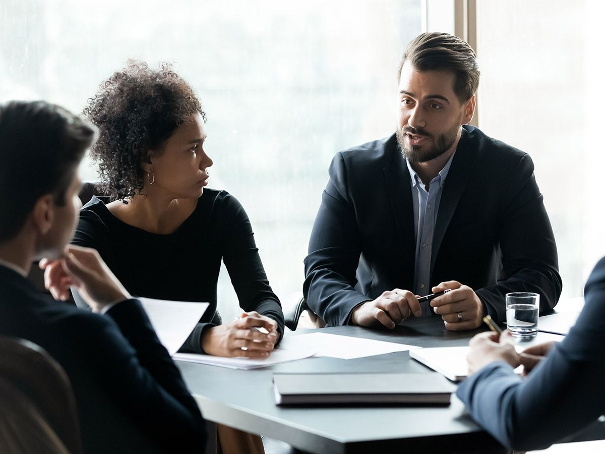 A legal team discussing with their client