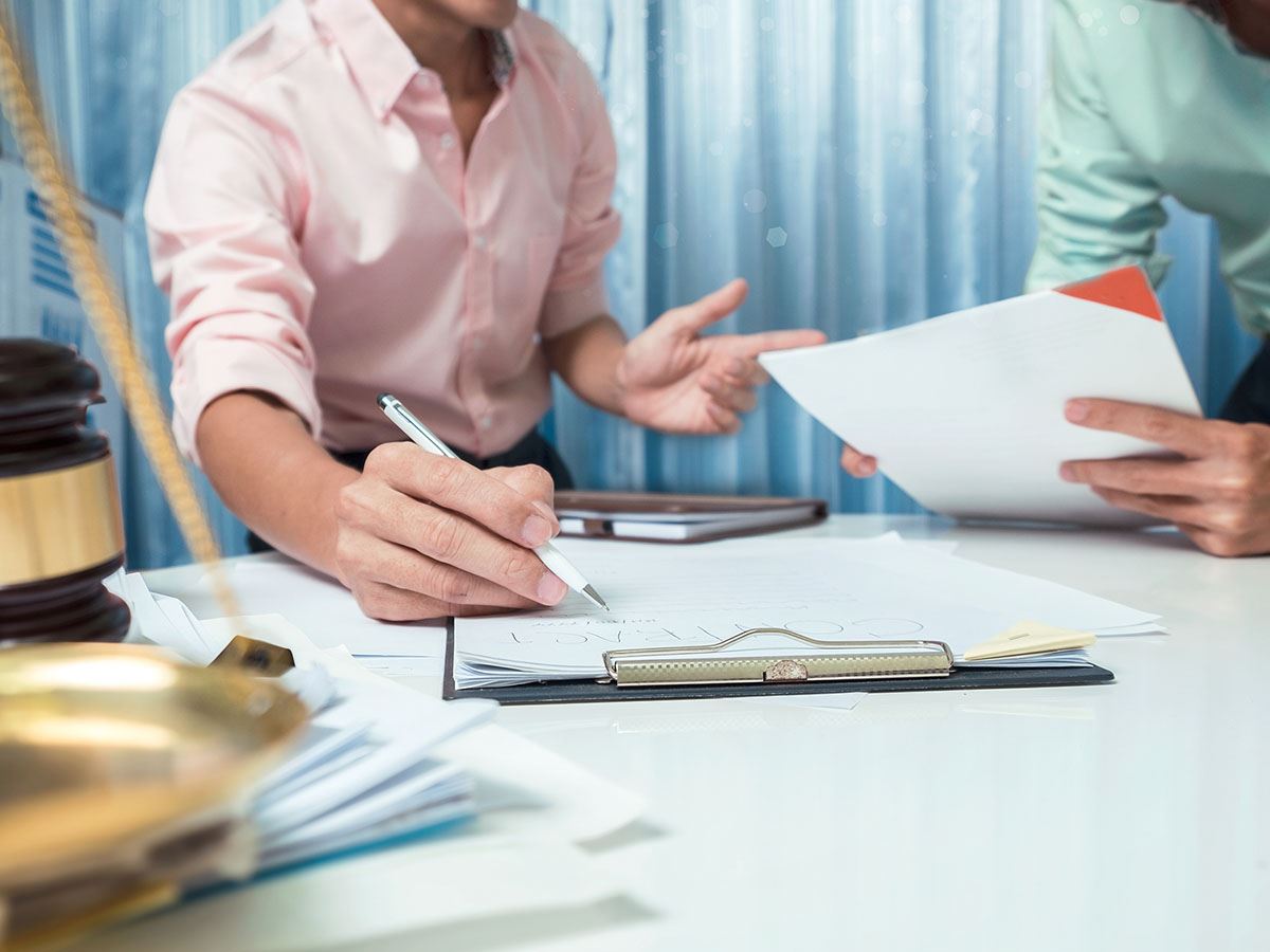 Two people talking with documents