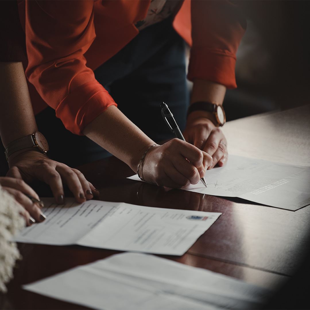 Women Signing Document