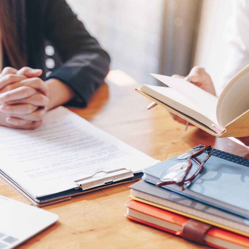 Two People With Documents and Books